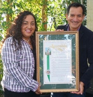 SELA PRAISED -- Assembly Speaker Anthony Rendon presents a Nonprofit of the Year resolution to SELA Executive Director Dr. Wilma Flores.